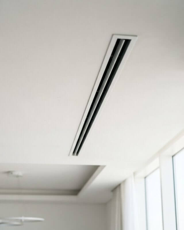 Minimalist linear AC diffuser in a luxury Dubai apartment ceiling