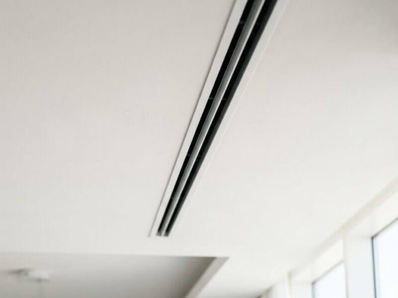 Minimalist linear AC diffuser in a luxury Dubai apartment ceiling